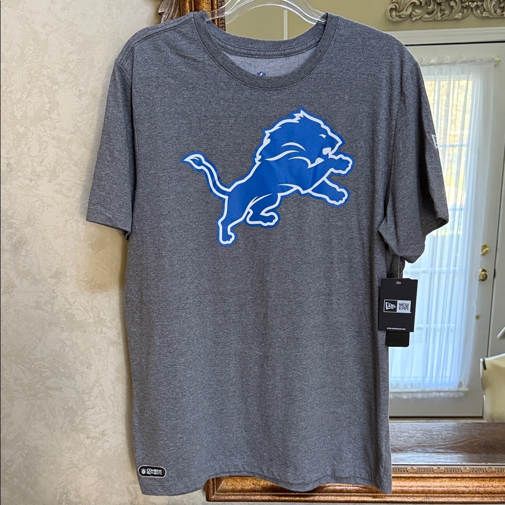 New Era NFL Gray Tee with Blue Lion Design.  Size L.